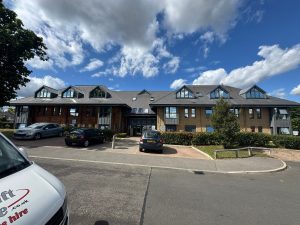 Side view of reflective window tint installation on London commercial property