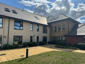 Exterior courtyard view of London commercial building with newly tinted office windows by S-Line Solarfilm